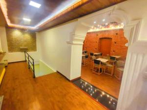an empty room with a table and a brick wall at Hotel Casa Santiago in Estación El Salto