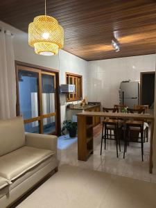 a living room with a couch and a table and chairs at Recanto no Centro in São Francisco Xavier