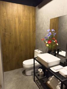 a bathroom with a white toilet and a sink at Upscale 2BR 2BA Apt w incredible Mountain Views in Oaxaca City