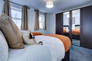 达特福德NEW! 5BR Gem by Prime Vault Properties, Town Centre Near Train Station with Driveway Parking的卧室配有带枕头的大型白色床