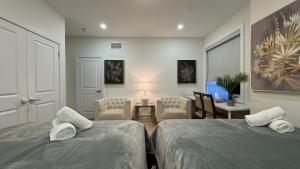 a bedroom with two beds and a living room at French Style Mansion In Prestigious Angus Glen Markham in Markham