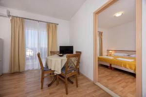 a room with a table and a bed and a mirror at Apartment Igrane 311b in Igrane