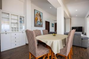 a kitchen and dining room with a table and chairs at Apartments by the sea Igrane, Makarska - 311 in Igrane