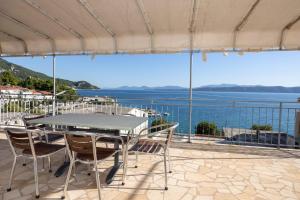 a table and chairs with a view of the water at Apartments by the sea Igrane, Makarska - 311 in Igrane