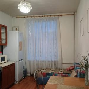 a kitchen with a table and a refrigerator and a window at Центр города 2 кв Набережная in Dnipro +4 photos