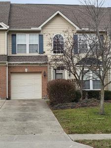 a brick house with a driveway and a garage at Dayton Gem in Dayton
