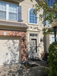 a white house with a garage door in front of it at Dayton Gem in Dayton +9 photos