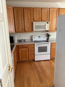 a kitchen with wooden cabinets and a stove and microwave at Dayton Gem in Dayton