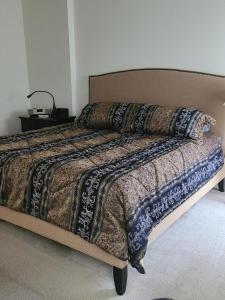 a bedroom with a large bed with a comforter at Dayton Gem in Dayton