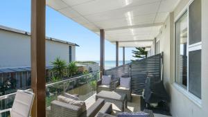 a balcony with chairs and a view of the ocean at Ocean Sunrise - Magical in Avoca Beach