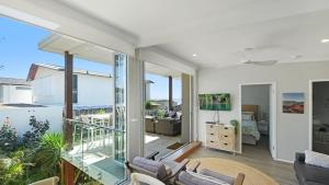 a living room with a view of the ocean at Ocean Sunrise - Magical in Avoca Beach +10 photos