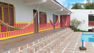 a house with a swimming pool in front of it at Finca El Turpial in Ulloa