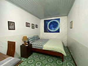 a small bedroom with a bed and a night stand at Nam Mỹ Vân Homestay - ĐH Công nghiệp Thái Nguyên in Thái Nguyên