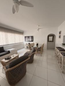 a living room with a couch and chairs and a table at Relax on the Beach in Guarujá