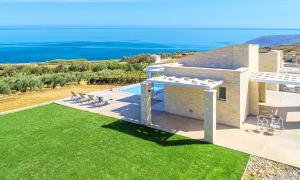 an aerial view of a house with a view of the ocean at Vista Mare Villa Beheizter Pool in Georgioupoli +23 photos