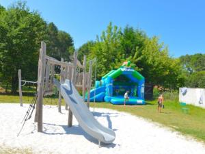a playground with a slide in the sand at Chalet 34m² 6 Pers - Terrasse et Salon de Jardin - API-1-52-708 in Sainte-Eulalie-en-Born