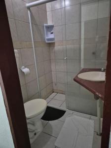 a bathroom with a toilet and a sink at pousada top mix apt 202 in Florianópolis