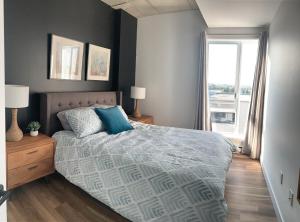 Ένα ή περισσότερα κρεβάτια σε δωμάτιο στο Le Caiman - Vieux-Quebec 2 Chambres à coucher & 2 salles de bains complètes