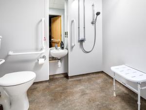 a bathroom with a toilet and a sink at ibis budget Sheffield Arena in Sheffield