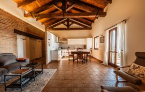 a living room with a couch and a table at Casa Nizza D'Oro in Castelnuovo
