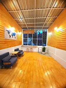 a large room with chairs and a table and a window at A Day Home in Chiang Mai