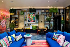 a living room with blue couches and a table at citizenM Miami South Beach in Miami Beach