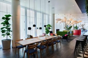 a dining room with a table and chairs at citizenM Miami South Beach in Miami Beach +23 photos