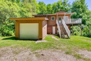 a small house with a garage and a staircase at Silver Spring Chalet in Pittsfield