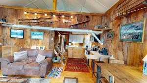 a living room with a couch and a kitchen at Pond View Cabin in Chittenden