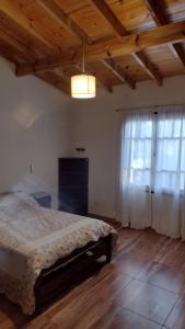 a bedroom with a bed and a large window at casa particular adrogue entrada individual in José Mármol