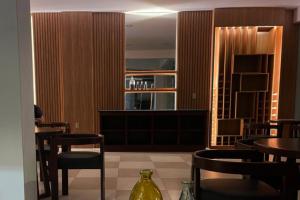 a restaurant with tables and chairs and a bar at Hotel Sky - Tarija in Tarija