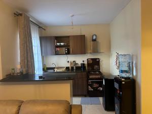 a small kitchen with a couch and a counter top at Frost Homes in Eldoret +5 photos