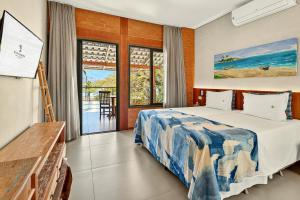 a bedroom with a bed and a view of the ocean at Hotel Velas do Engenho in Ilhabela +66 photos