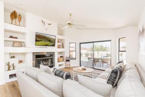 a living room with white furniture and a fireplace at Western Hills-Heated Pool-In Fountain Hills in Fountain Hills