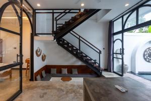 a staircase in the living room of a house at Chopik Villa in Dalung +12 photos