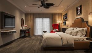 a bedroom with a large bed and a red chair at Dream Future Vang Vieng Hotel in Vang Vieng
