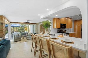 Una cocina y una sala de estar con mesa y sillas. en The Coastal Duo Escape, en West Palm Beach
