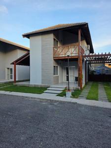 a large house with a porch and a balcony at Praia dos Carneiros Condomínio Village in Tamandaré