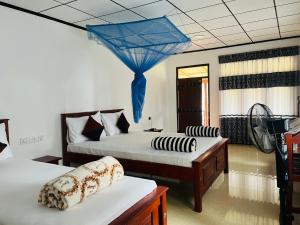 En eller flere senge i et værelse på Nine Arch Homestay