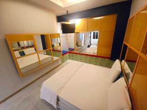 a bedroom with a bed and a mirror at Save Hotel เซฟ โฮเทล 