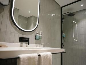 a bathroom with a sink and a mirror at Novotel Riyadh Al Anoud in Riyadh +111 photos