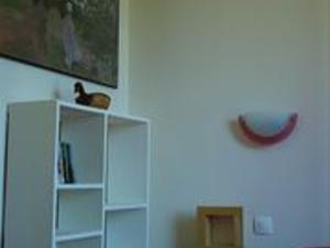 a room with a white cabinet and a red object on the wall at Charmant gîte pour 2 au cœur de la Sologne avec terrasse - FR-1-491-409 in Neung-sur-Beuvron