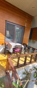 a patio with a table and chairs on a house at Secret Thai Peace No1 in Thongsala