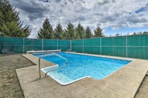 a large swimming pool with a fence around it at Log Cabin Luxury Fire Pit Nights Autumn Midweek - 35 Off Promo! in Pleasant Mount