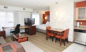a hotel room with a bed and a desk and a room at MainStay Suites Appleton Airport - Fox River Mall Area in Appleton +20 photos