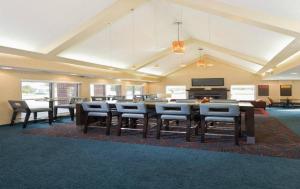 a large room with a large table and chairs at MainStay Suites Appleton Airport - Fox River Mall Area in Appleton