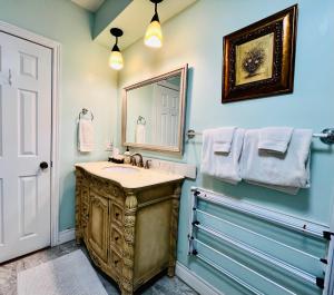 a bathroom with a sink and a mirror at Barker House 1# Suite-heart of oldtown in Niagara on the Lake +11 photos