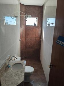 a bathroom with a toilet and a sink and a shower at Lar Doce Lar Realizando Sono!!! in Arcos