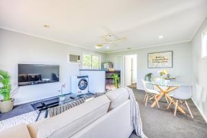 a living room with a couch and a table at StayAU 4BR Family-Friendly Home near Deakin Uni in Whittington