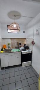 een keuken met een spoelbak en een fornuis bovenste oven bij Paz in Estación Delta